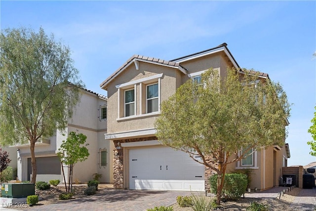 10052 Silver Comet Ct, Las Vegas, NV 89178 - view of front facade with a garage, decorative driveway, stucco siding, and a tile roof
