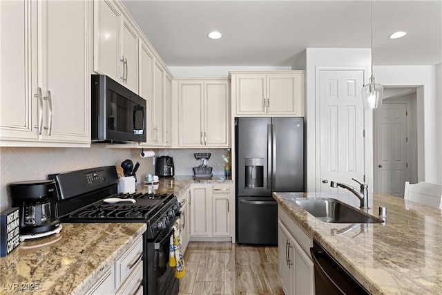 10052 Silver Comet Ct, Las Vegas, NV 89178 - kitchen featuring black appliances, a sink, light stone counters, decorative backsplash, and recessed lighting