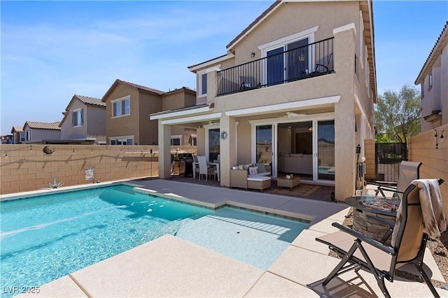 10052 Silver Comet Ct, Las Vegas, NV 89178 - rear view of house with a balcony, a fenced backyard, stucco siding, and a patio