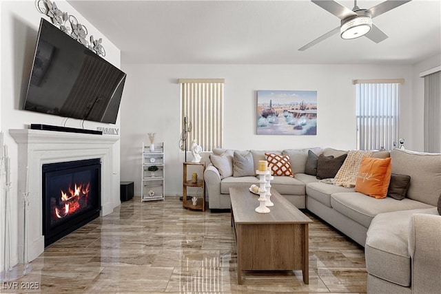10052 Silver Comet Ct, Las Vegas, NV 89178 - living room with a glass covered fireplace, a ceiling fan, and light marble finish flooring