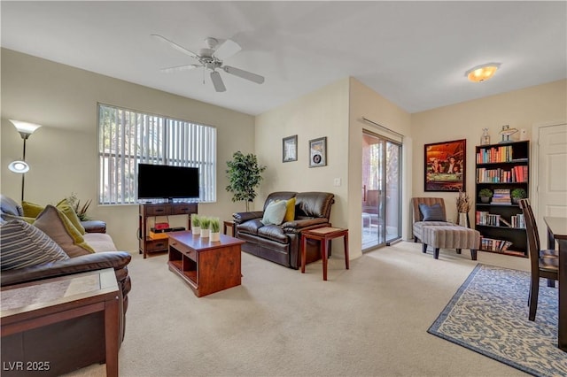 living room with light carpet and a ceiling fan