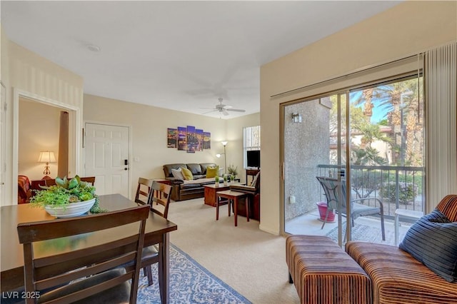 carpeted living room with ceiling fan