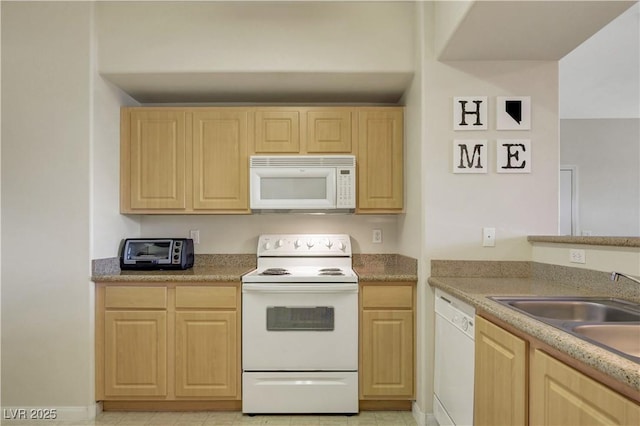 kitchen with a sink, light countertops, white appliances, light brown cabinetry, and a toaster