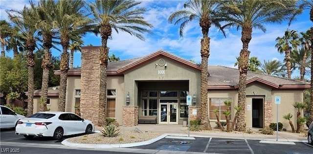 view of building exterior with uncovered parking