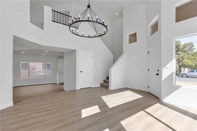 6509 Old Oxford Ave, Las Vegas, NV 89108 - foyer entrance featuring wood finished floors, plenty of natural light, a chandelier, and a towering ceiling