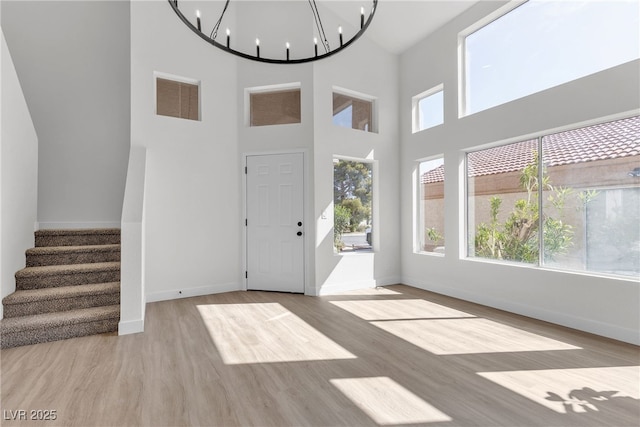 6509 Old Oxford Ave, Las Vegas, NV 89108 - foyer featuring an inviting chandelier, visible vents, stairway, wood finished floors, and baseboards