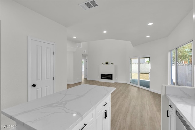 6509 Old Oxford Ave, Las Vegas, NV 89108 - kitchen featuring light wood-style flooring, light stone counters, visible vents, and recessed lighting