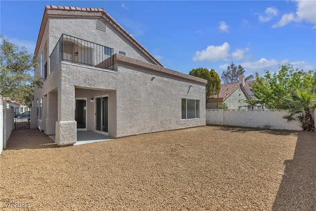 6509 Old Oxford Ave, Las Vegas, NV 89108 - back of property featuring a fenced backyard, stucco siding, a patio area, and a balcony