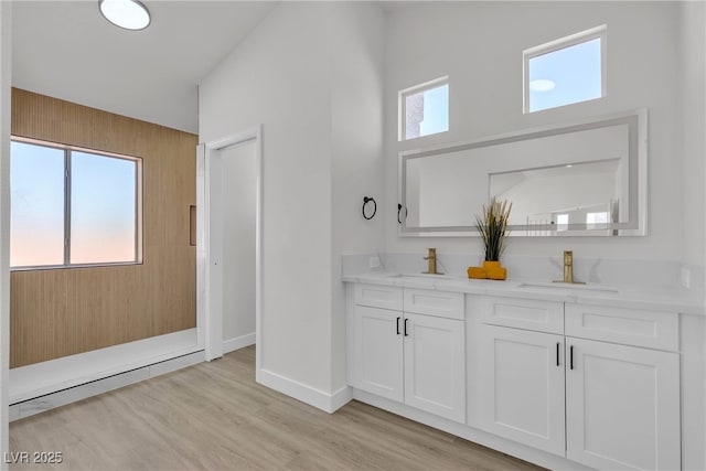 6509 Old Oxford Ave, Las Vegas, NV 89108 - full bath featuring a healthy amount of sunlight, baseboards, a sink, and wood finished floors