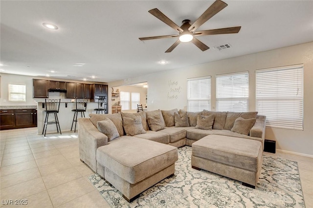 living area with recessed lighting, light tile patterned floors, visible vents, and a ceiling fan