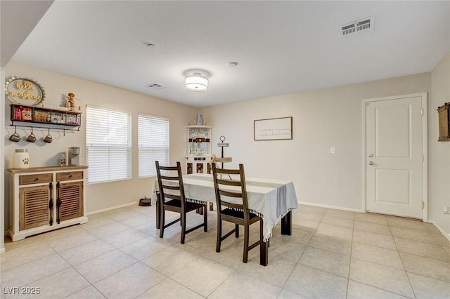 dining area with visible vents, baseboards, and light tile patterned floors