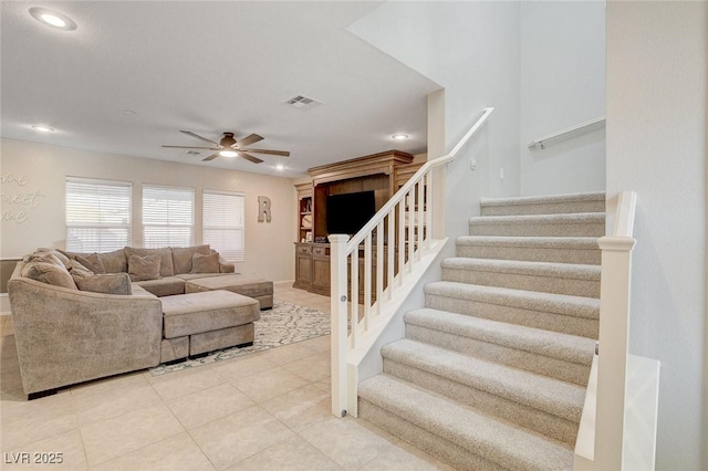 living area featuring visible vents, light tile patterned floors, ceiling fan, recessed lighting, and stairs