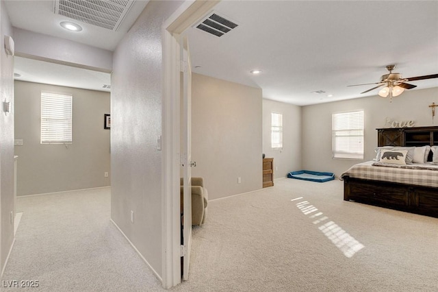 carpeted bedroom featuring recessed lighting, visible vents, and baseboards