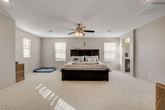 bedroom with visible vents, ceiling fan, and carpet flooring
