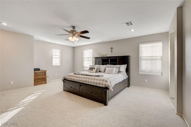 bedroom featuring visible vents, baseboards, a ceiling fan, recessed lighting, and light colored carpet