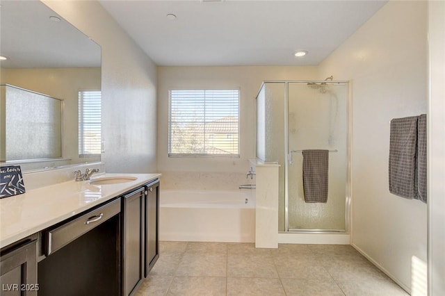 full bathroom featuring tile patterned flooring, a shower stall, vanity, and a garden tub