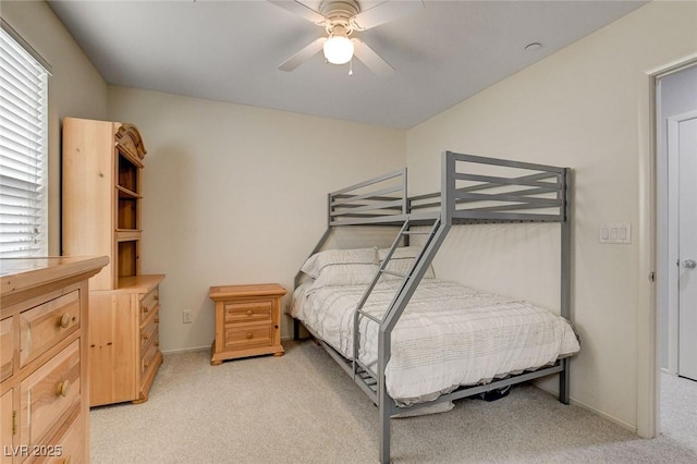 bedroom with baseboards, a ceiling fan, and light colored carpet