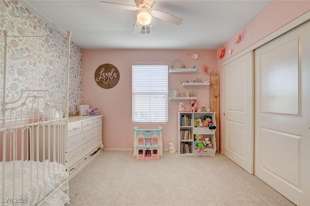 carpeted bedroom with visible vents, a closet, and ceiling fan