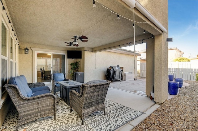 view of patio / terrace with a ceiling fan, area for grilling, and fence