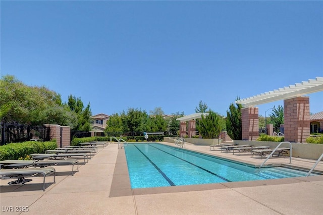 community pool with a patio area, a pergola, and fence