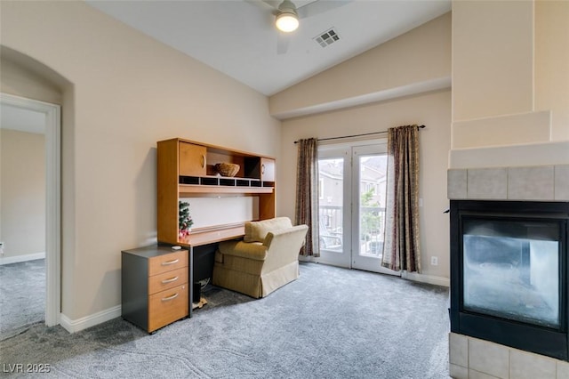 home office featuring light carpet, lofted ceiling, a ceiling fan, and visible vents