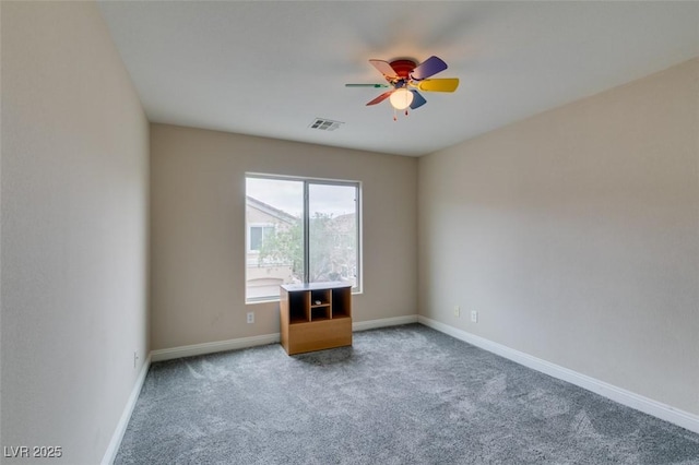 spare room featuring visible vents, baseboards, a ceiling fan, and carpet flooring