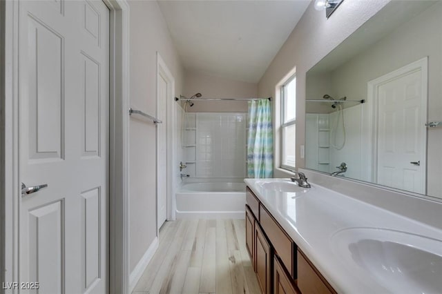 full bathroom with double vanity, shower / bath combination with curtain, a sink, and wood finished floors