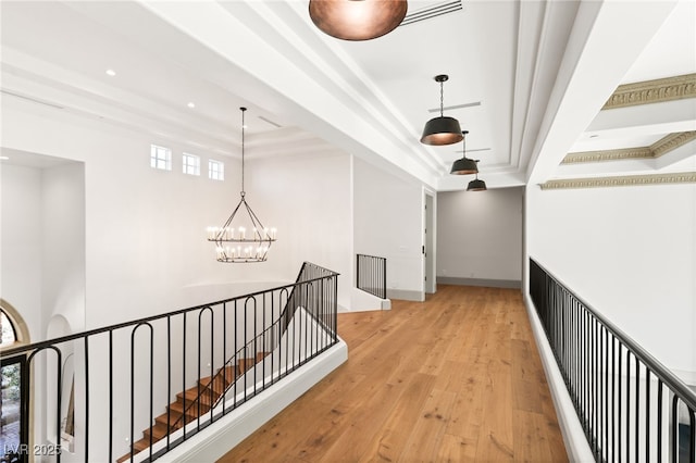 15 Vintage Canyon St, Las Vegas, NV 89141 - hallway with an inviting chandelier, an upstairs landing, a tray ceiling, recessed lighting, and hardwood / wood-style floors