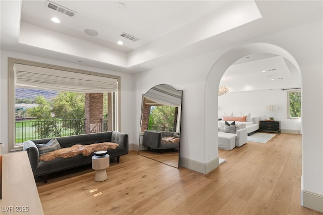 15 Vintage Canyon St, Las Vegas, NV 89141 - living area featuring visible vents, light wood-style flooring, a raised ceiling, and baseboards