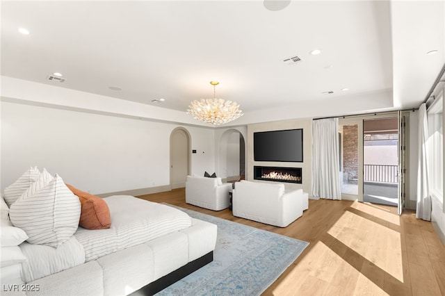15 Vintage Canyon St, Las Vegas, NV 89141 - bedroom with a notable chandelier, access to outside, light wood-style flooring, visible vents, and arched walkways