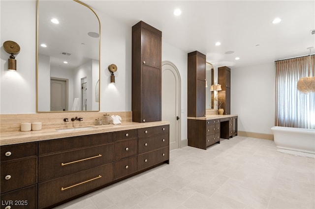 15 Vintage Canyon St, Las Vegas, NV 89141 - bathroom featuring tasteful backsplash, vanity, baseboards, a soaking tub, and recessed lighting