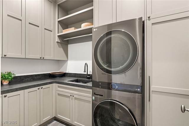 15 Vintage Canyon St, Las Vegas, NV 89141 - laundry area with stacked washer and clothes dryer, a sink, and cabinet space