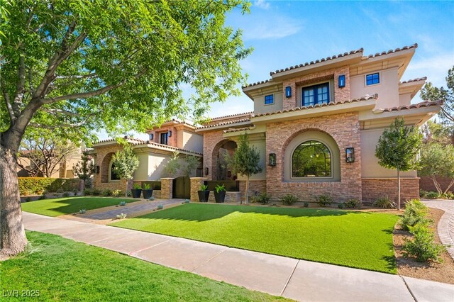 15 Vintage Canyon St, Las Vegas, NV 89141 - mediterranean / spanish house with stucco siding, stone siding, and a front lawn