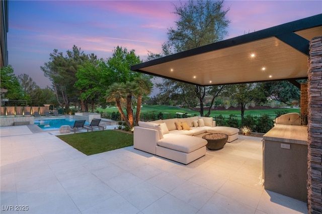 15 Vintage Canyon St, Las Vegas, NV 89141 - patio terrace at dusk featuring an outdoor pool, an outdoor living space with a fire pit, and a yard