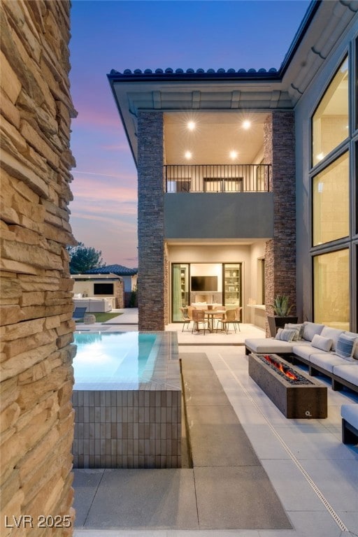 15 Vintage Canyon St, Las Vegas, NV 89141 - exterior space with an outdoor pool, an outdoor living space with a fire pit, and a balcony