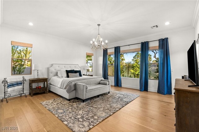 bedroom featuring a chandelier, hardwood / wood-style flooring, ornamental molding, recessed lighting, and baseboards