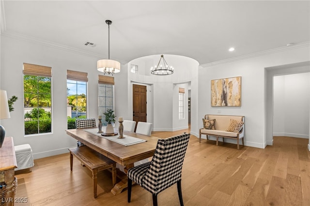 dining room with light wood-style floors, a chandelier, crown molding, baseboards, and recessed lighting