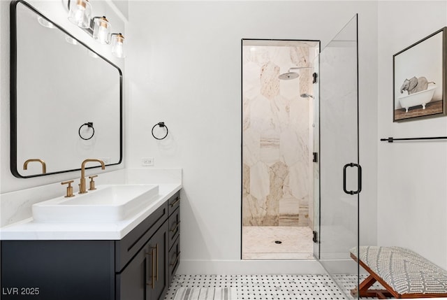full bath featuring a shower stall, baseboards, vanity, and tile patterned floors