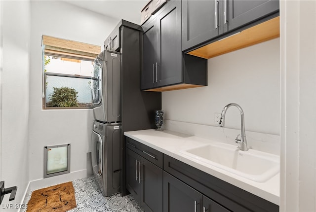 washroom featuring stacked washer / dryer and cabinet space