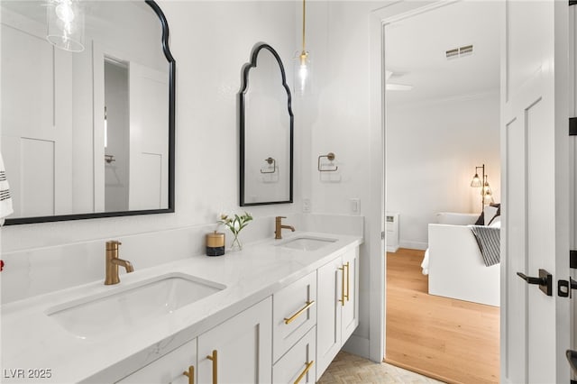 full bathroom featuring ornamental molding, double vanity, and parquet floors