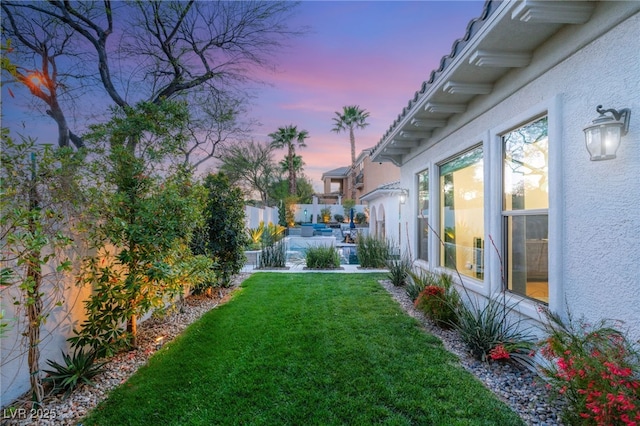 yard at dusk featuring outdoor lounge area