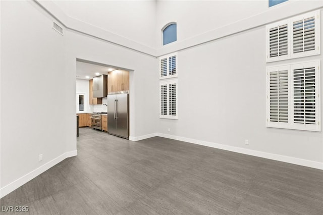 2236 Timber Rose Dr, Las Vegas, NV 89134 - unfurnished living room featuring visible vents, baseboards, and dark wood finished floors