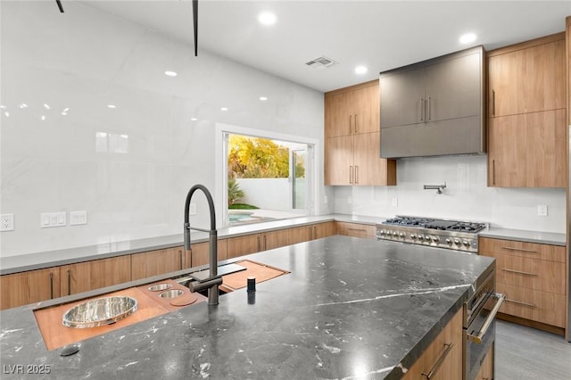 2236 Timber Rose Dr, Las Vegas, NV 89134 - kitchen with visible vents, range, and modern cabinets