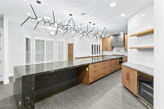 2236 Timber Rose Dr, Las Vegas, NV 89134 - kitchen featuring wine cooler, an inviting chandelier, and modern cabinets