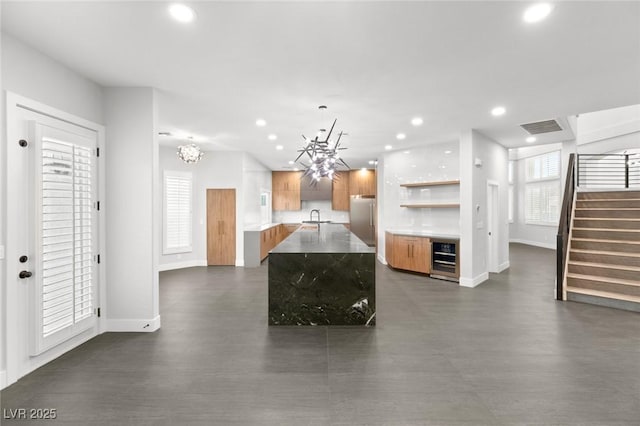 2236 Timber Rose Dr, Las Vegas, NV 89134 - kitchen with visible vents, stainless steel fridge, a sink, a chandelier, and recessed lighting