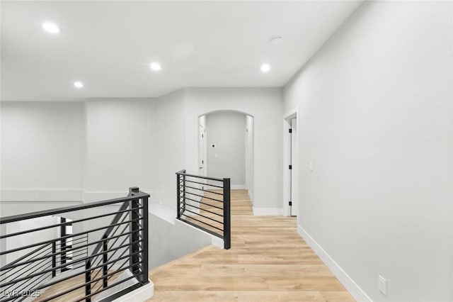 2236 Timber Rose Dr, Las Vegas, NV 89134 - hall featuring recessed lighting, arched walkways, an upstairs landing, and light wood-type flooring
