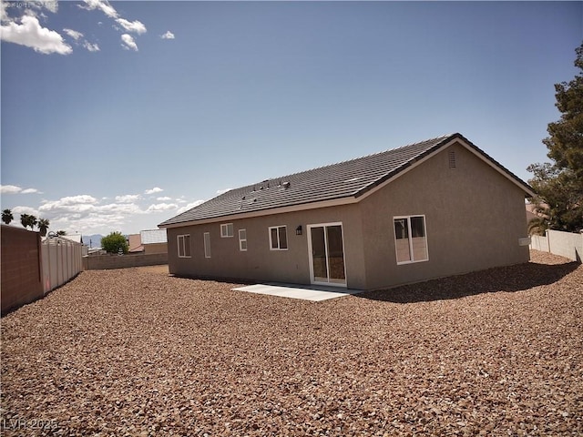 1931 Rose Ct, Pahrump, NV 89048 - back of house with a patio area, stucco siding, and a tiled roof