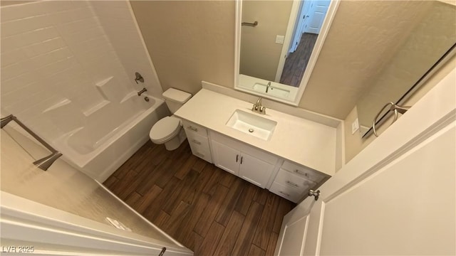 bathroom with vanity, shower / bathing tub combination, toilet, and wood finished floors