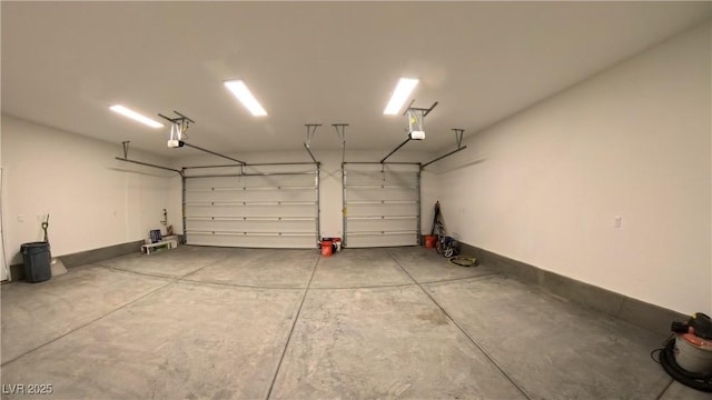 garage with baseboards and a garage door opener