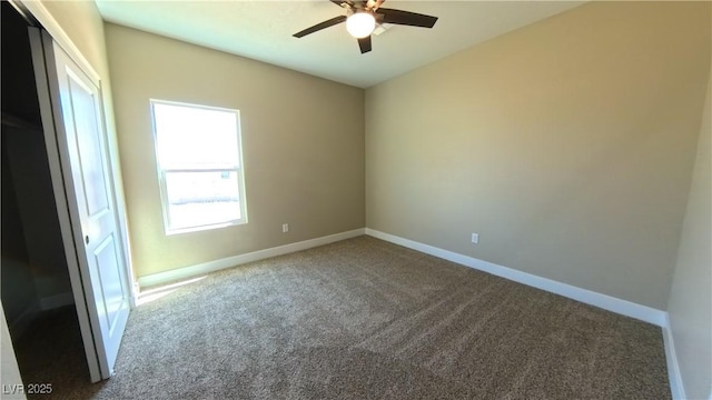 empty room featuring baseboards, carpet flooring, and ceiling fan